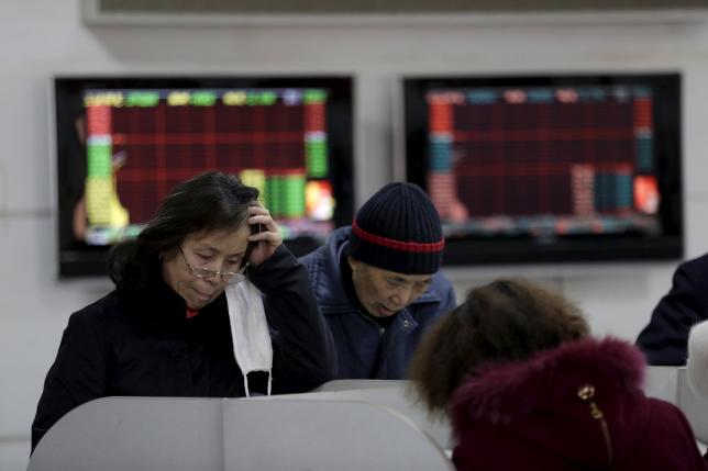 Pic Investors look at computer screens showing stock information on the first trading day after the week-long Lunar New Year holiday at a brokerage house in Shanghai China