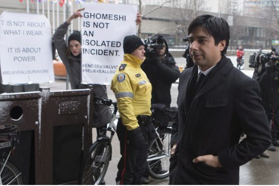 Jian Ghomeshi walks past protesters as he arrives at court for day six of his trial on Tuesday Feb. 9 2016