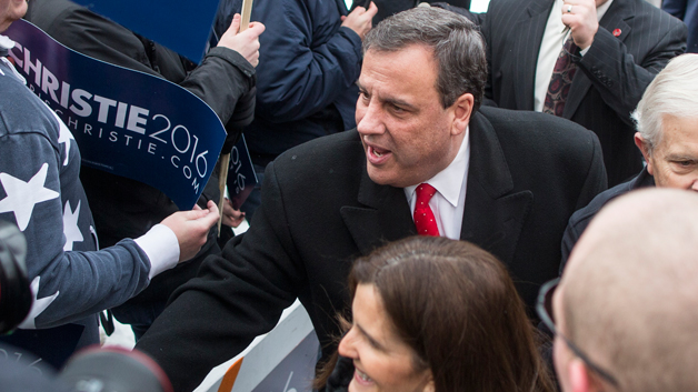 Republican presidential candidate New Jersey Governor Chris Christie shakes hands with voters outside the polling place at Webster School