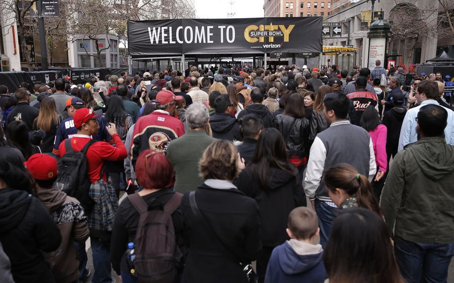 Fans fill the entrance into a security checkpoint during the opening of Super Bowl City the free fan experience in San Francisco