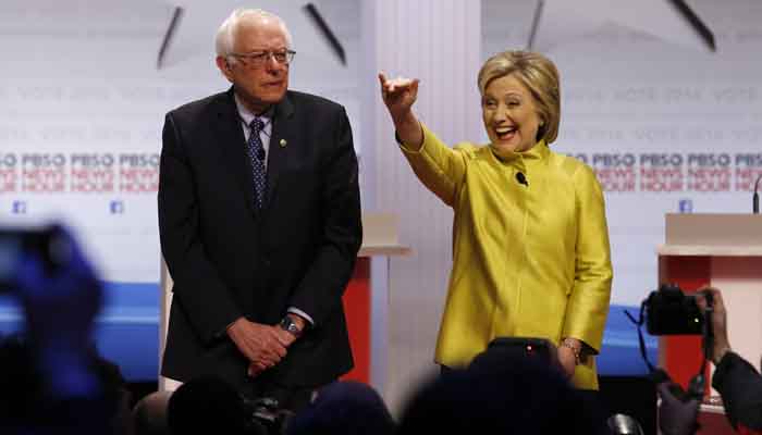 Democratic presidential candidates Sen. Bernie Sanders I-Vt left and Hillary Rodham Clinton take the stage before a Democratic presidential primary debate at the University of Wisconsin-Milwaukee in Milwaukee