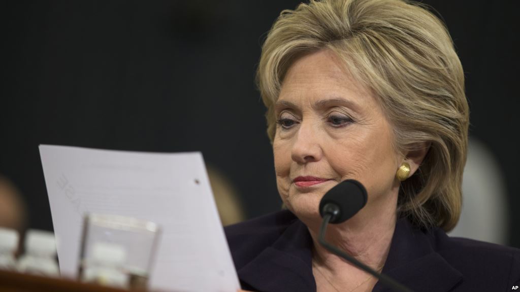 FILE- Democratic presidential candidate former Secretary of State Hillary Rodham Clinton looks at an email sent by Ambassador Chris Stevens during her testimony before the House Benghazi Committee Oct. 22 2015 on Capitol Hill in Washington