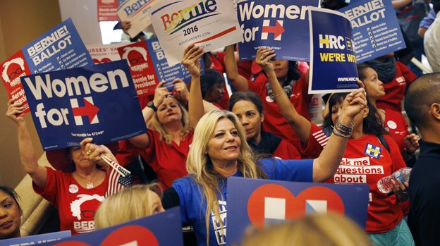 Supporters of Hillary Clinton and Bernie Sanders cheer on their presidential candidates before entering a caucus site during the Nevada Democratic caucus Saturday Feb. 20 2016 in Las Vegas