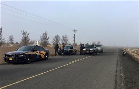 Authorities wait near the Malheur National Wildlife Refuge Thursday Feb. 11 2016 near Burns Ore. The last four armed occupiers of the national wildlife refuge in eastern Oregon said they would turn themselves in Thursday morning