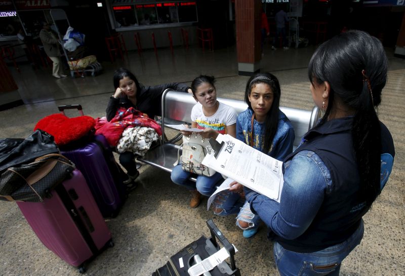 A Colombian health worker gives travellers information on how to prevent the spread of the Zika virus. The virus has been linked to the devastating birth defect microcephaly which prevents foetus brains from developing properly. – Reuters February 1