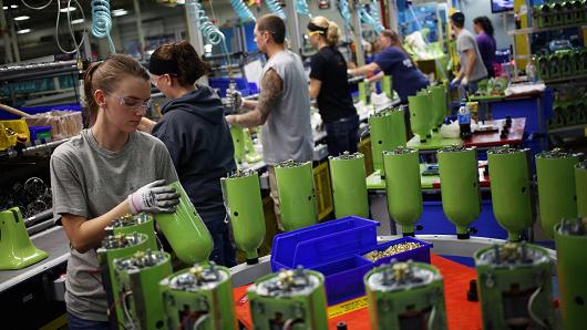 A worker assembles stand mixers on the production line at the Whirlpool Corp. Kitchen Aid manufacturing facility in Greenville Ohio