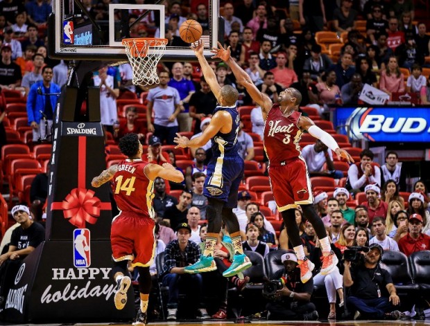 Eric Gordon #10 of the New Orleans Pelicans shoots as Dwyane Wade #3 of the Miami Heat defends during the game at American Airlines Arena