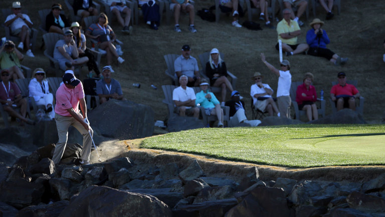 Dufner plays from the rocks on the 17th hole to save an unlikely par and force a play-off