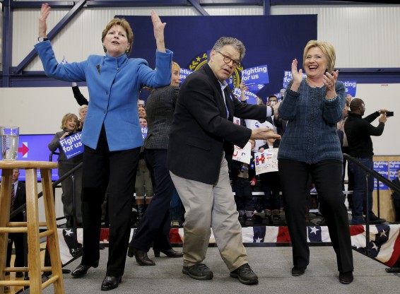 Democratic presidential candidate Hillary Clinton is joined onstage by senators Al Franken and Jeanne Shaheen at a campaign rally in Portsmouth New Hampshire