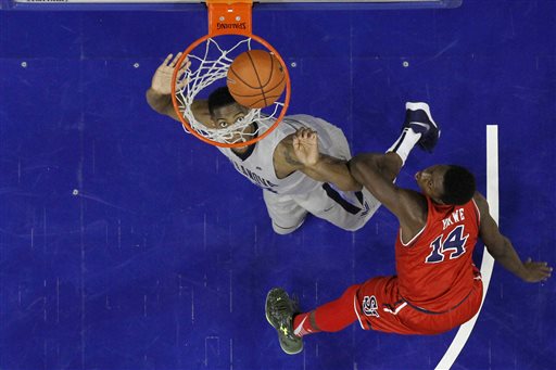 Villanova's Darryl Reynolds left watches a shot by St. John's Kassoum Yakwe during the first half of an NCAA college basketball game Saturday Feb. 13 2016 in Philadelphia. Villanova won 73-63