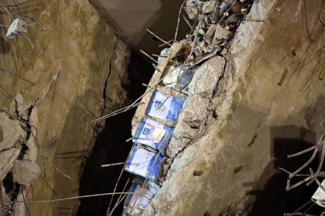 Blue paint cans seen sandwiched in between a layer of concrete appear to have been used in the construction of Wei Kuan apartment complex which collapsed in the 6.4 magnitude earthquake on Saturday