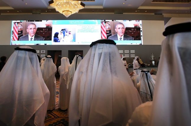 Emirati officials watch U.S. President Barack Obama's keynote address at the opening ceremony of the World Government Summit in Dubai United Arab Emirates Monday Feb. 8 2016. Those gathered for the World Government Summit in Dubai offered no immediate