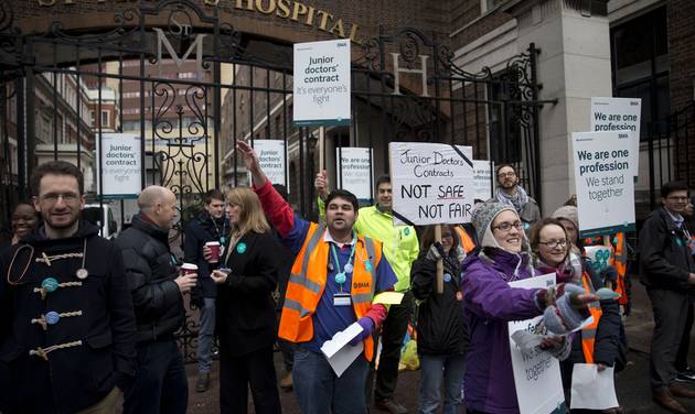 Junior doctors supported by other healthcare workers take part in a 24-hour strike as they stand on a picket line with placards outside St Mary's Hospital which includes the private wing where the two royal babies were born in recent years in Londo