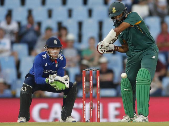 South Africa's Hashim Amla plays a shot as England's Jos Buttler looks on during the third One Day International cricket match in Pretoria