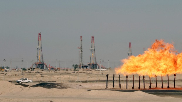 Excess gas is burnt off at a pipeline at Rumaila oilfield in Basra southeast of Baghdad