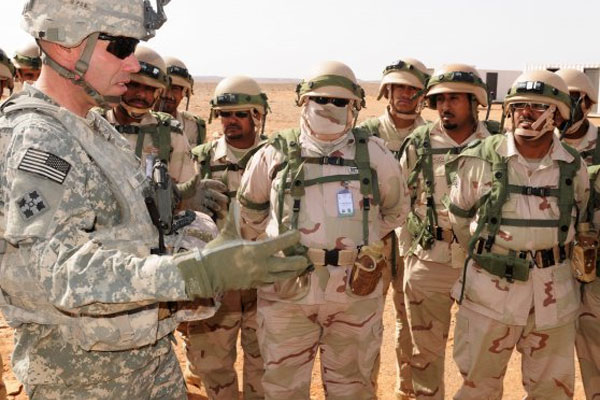 US Army Lt. Col. Joshua Wright briefs Saudi troops during an April 2014 training exercise in Saudi Arabia. The Syrian foreign minister has warned that any Saudi or other foreign troops who enter Syria will'return home in coffins