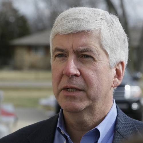 Michigan Gov. Rick Snyder is interviewed after visited a church that's distributing water and filters to its predominantly Latino parishioners in Flint Mich. Snyder will propose spending $195