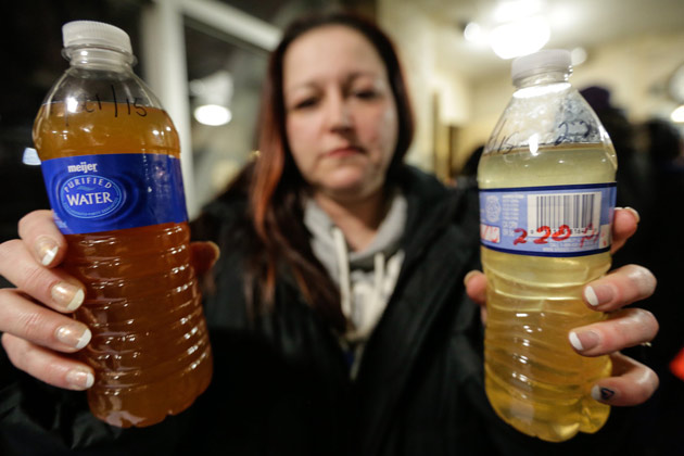 Flint resident Lee Anne Walters shows water samples from her home