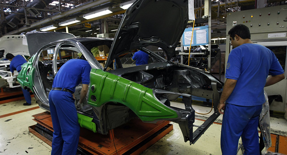 An Iranian man works on a Peugeot 206 car at the Iran Khodro auto plant west of Tehran