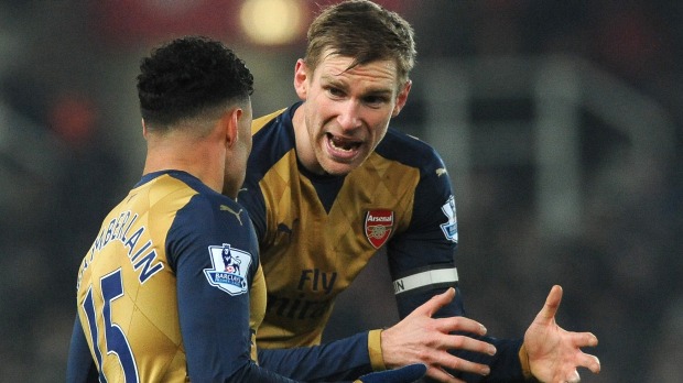 Frustration Arsenal captain Per Mertesacker right and Alex Oxlade Chamberlain plot a way through the Stoke defence