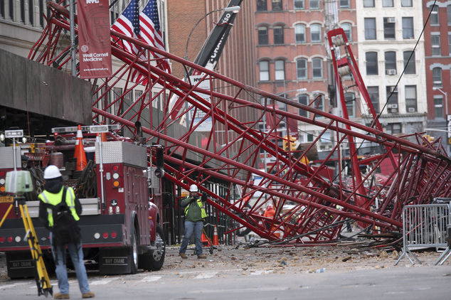 Firefighters and construction crews work on clearing a collapsed crane Saturday Feb. 6 2016 in New York. Officials are working to determine why a huge