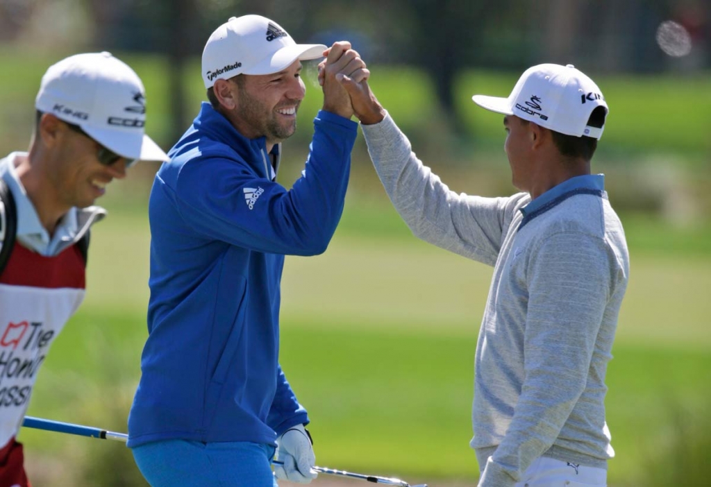 Sergio Garcia of Spain left high fives Rickie Fowler after making an eagle on the second hole during the first round of the Honda Classic golf tournament Thursday Feb. 25 2016 in Palm Beach Gardens Fla