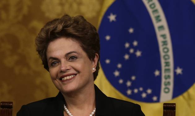 Brazil's President Dilma Rousseff listens to Ecuador's President Rafael Correa as he speaks at the end of their meeting in Quito Ecuador Tuesday Jan. 26 2016. President Rousseff is in Quito to attend the IV Summit of Heads of State and Gove