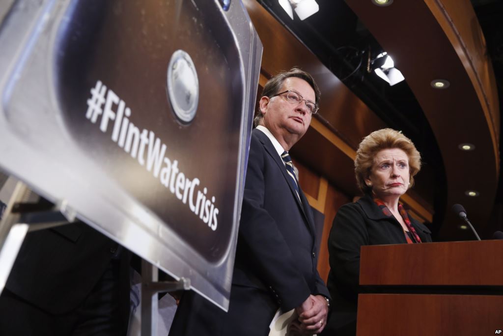 FILE- Sen. Gary Peters D-Mich. left and Sen. Debbie Stabenow D-Mich. discuss proposed legislation to help Flint Michigan with its current water crisis during a news conference on Capitol Hill in Washington Jan. 28 2016