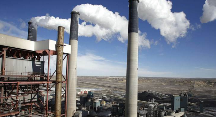 Steam rises from the stakes of the coal-fired Jim Bridger Power Plant outside Point of the Rocks Wyoming in this file