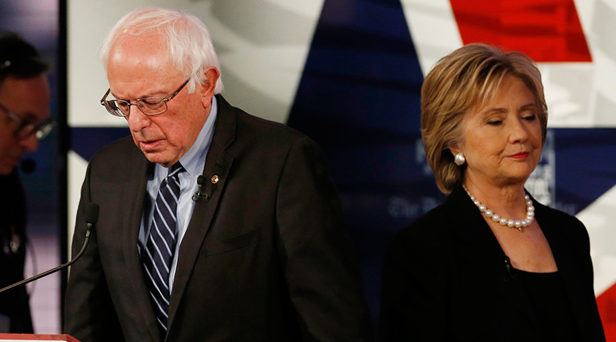 Democratic U.S. presidential candidate former Secretary of State Hillary Clinton walks past fellow candidate and Senator Bernie Sanders