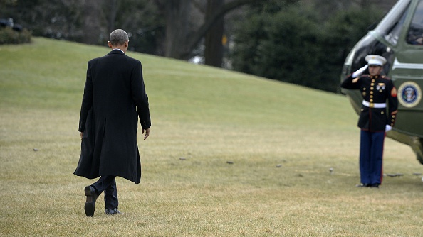 U.S. President Barack Obama walks out of the residence toward Marine One while departing the White House