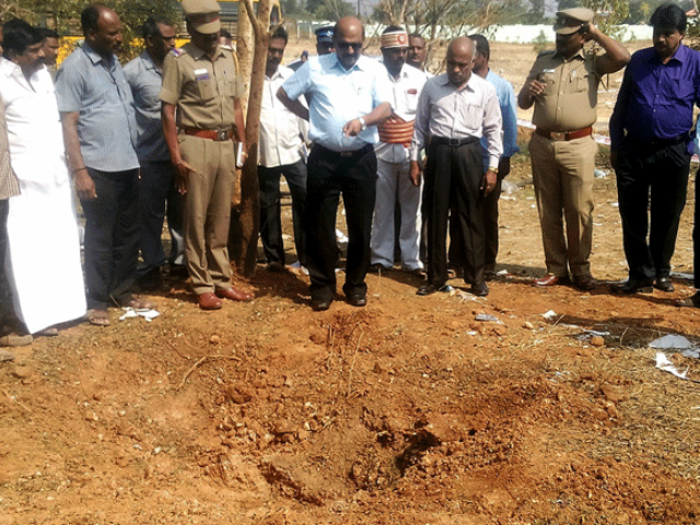 Indian authorities inspect the site of a suspected meteorite landing