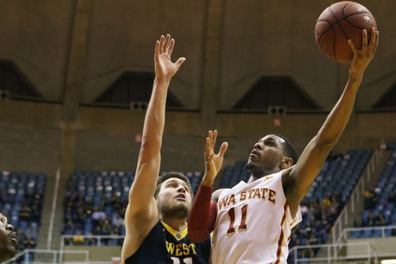 Monte Morris right drives to the basket as West Virginia forward Nathan Adrian left attempts to block his shot during the first half of an NCAA college basketball game Monday Feb 22 2016 in Morgantown