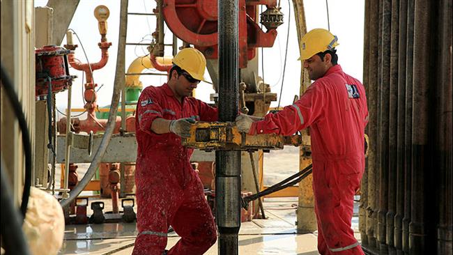 Iranian workers operate a drilling rig at South Yaran oilfield