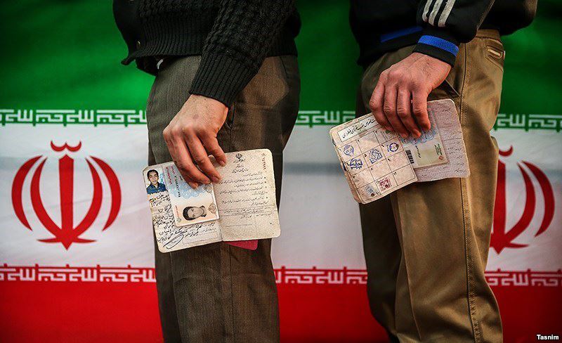 Iranians wait to cast their votes in the parliamentary elections in Tehran on February 26