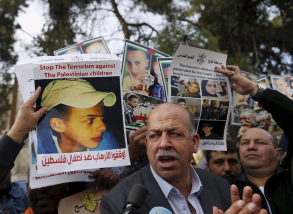 Hussein Abu Khudair, father of murdered Palestinian teenager Mohammed Abu Khudair takes part in a protest outside the Jerusalem District Court in this