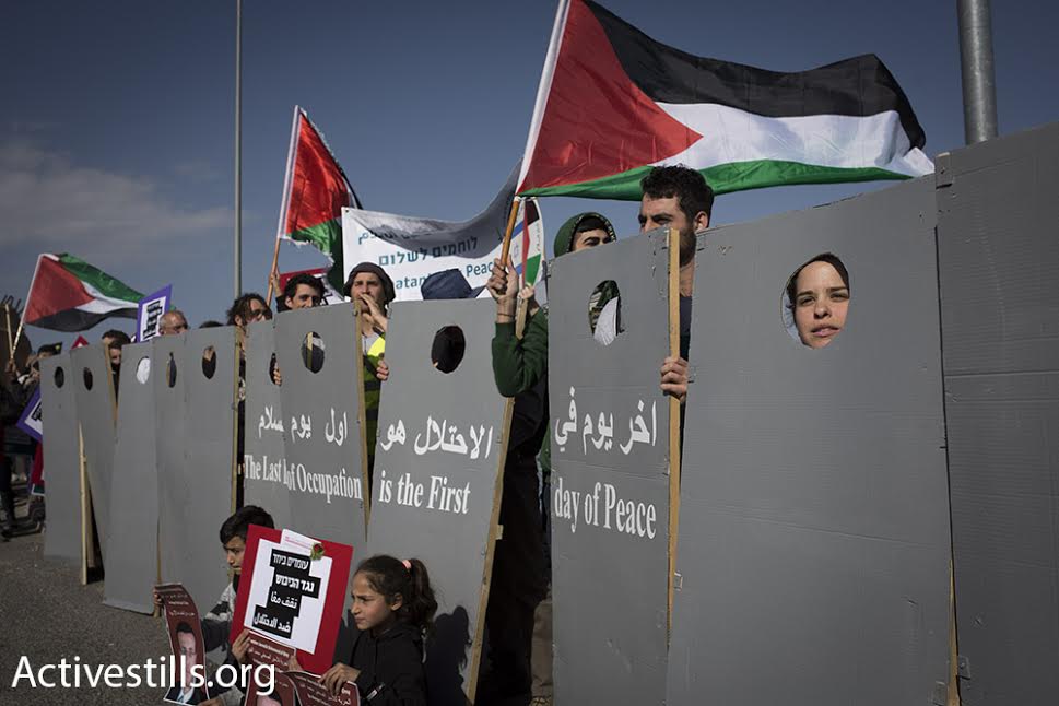 Israelis and Palestinians march toward the'tunnels checkpoint in the West Bank in a joint demonstration against the occupation