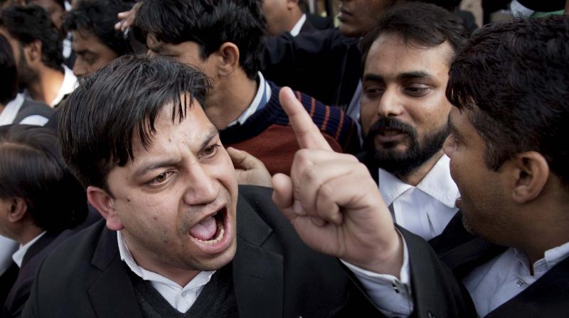 A lawyer argues with another as they clash among themselves before JNUSU President Kanhaiya Kumar was produced at Patiala House courts in New Delhi