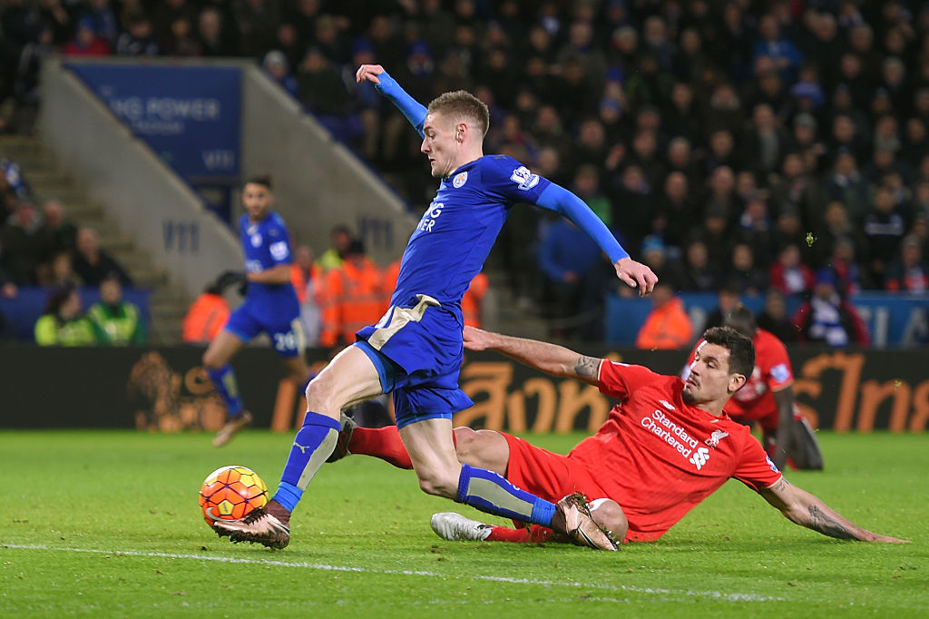 LEICESTER ENGLAND- FEBRUARY 02 Jamie Vardy of Leicester City scores his team's second goal while Dejan Lovren of Liverpool tries to block during the Barclays Premier League match between Leicester City and Liverpool at The King Power Stadium on Fe