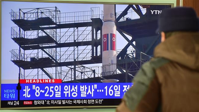 A man watches a news report on North Korea's planned rocket launch as the television screen shows the footage of Unha-3 rocket launch in 2012 at a railway station in Seoul South Korea