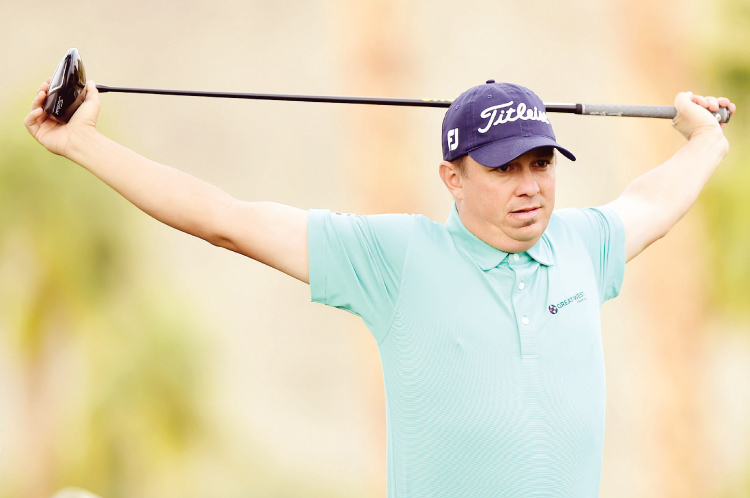 Jason Dufner stretches before playing his tee shot on the 11th hole at the Career Builder Challenge in La Quinta California Saturday. — AFP