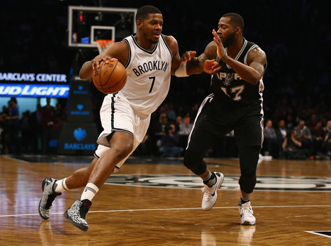 Joe Johnson #7 of the Brooklyn Nets drives against Jonathon Simmons #17 of the San Antonio Spurs during their game at the Barclays Center