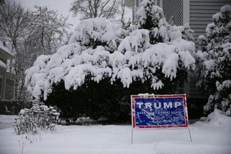 A campaign sign for Republican presidential candidate Donald Trump is seen during Friday’s storm in Concord N.H