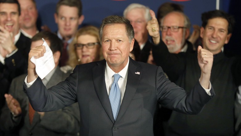 John Kasich arrives to a cheering crowd Tuesday in Concord N.H. at his primary night campaign rally