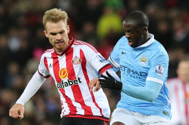 Jan Kirchhoff of Sunderland takes on Yaya Toure of Manchester City during the Barclays Premier League match between Sunderland and Manchester City at The Stadium of Light