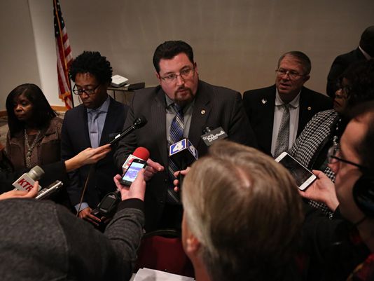 Ferguson mayor Mayor James Knowles III center talks to the media after the Ferguson Mo. city council meeting in Ferguson on Tuesday Feb. 9 2016 where the council voted to approve a modified consent decree with the United States Department of Justic