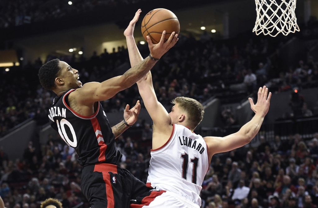 Toronto Raptors guard De Mar DeRozan drives to the basket on Portland Trail Blazers forward Meyers Leonard during the second half of an NBA basketball game in Portland Oregon Thursday Feb. 4 2016. AP