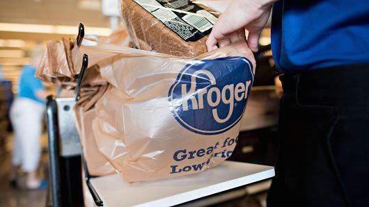 An employee bags a customer's purchases at a Kroger store in Peoria Illinois