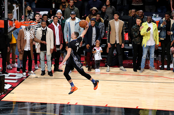 TORONTO ON- FEBRUARY 13 Zach La Vine of the Minnesota Timberwolves dunks as NBA players look on in the Verizon Slam Dunk Contest during NBA All Star Weekend 2016 at Air Canada Centre