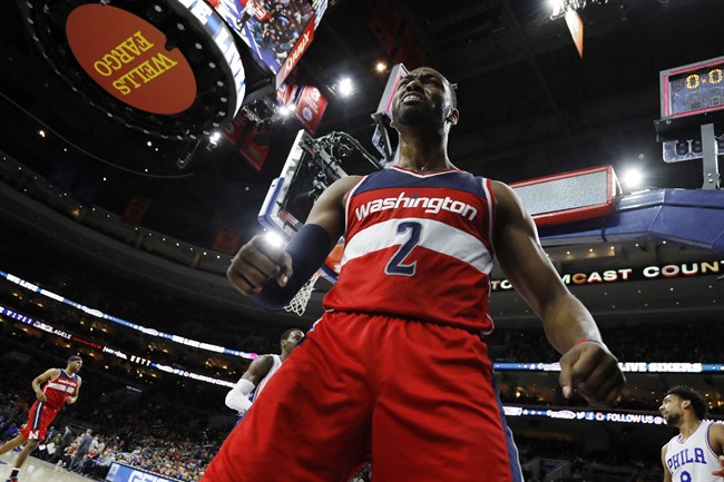 Washington Wizards John Wall reacts after scoring on the final play of the first half of the team's NBA basketball game against the Philadelphia 76ers Friday Feb. 26 2016 in Philadelphia